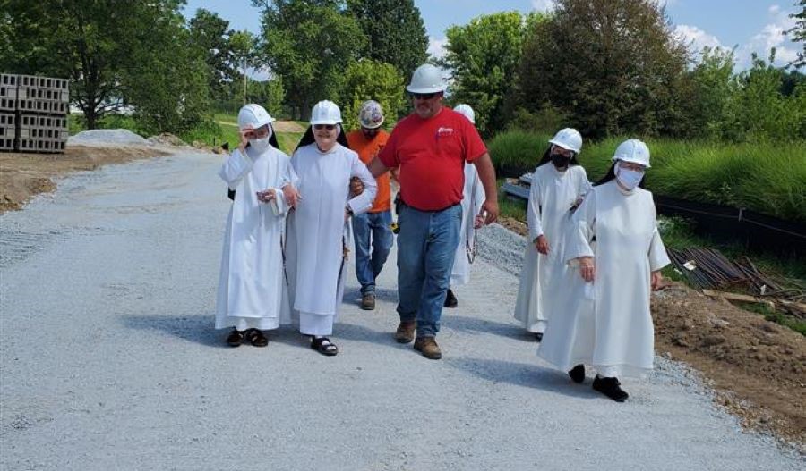 O'Shea team walking with nuns on Monastery property in a paint splatter